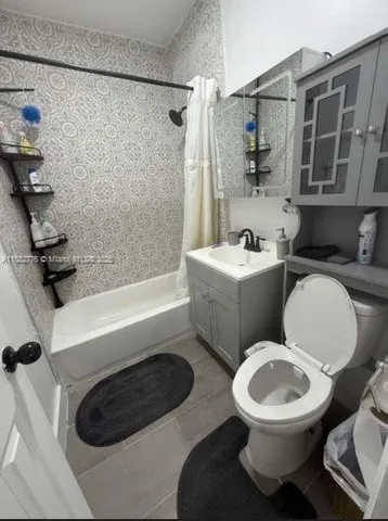 a bathroom with a toilet a sink and bathtub