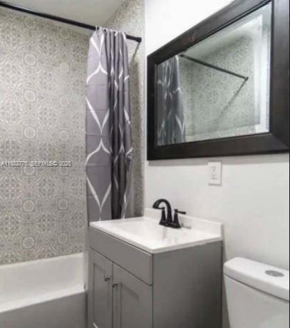 1336 Northwest 38th Street, Unit 1 Miami, FL 33142 - Photo 13 of 33 a bathroom with a toilet sink and mirror