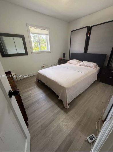 1336 Northwest 38th Street, Unit 1 Miami, FL 33142 - Photo 15 of 33 a bedroom with a bed and window