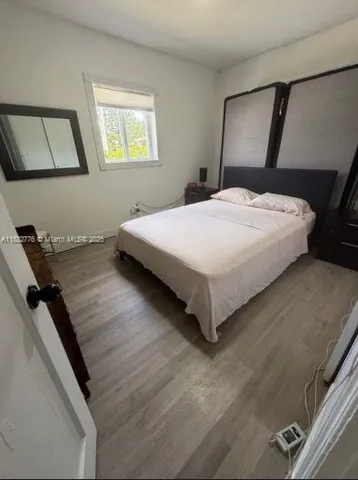 a bedroom with a bed and window