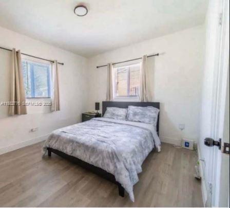 1336 Northwest 38th Street, Unit 1 Miami, FL 33142 - Photo 18 of 33 a bedroom with a bed and window