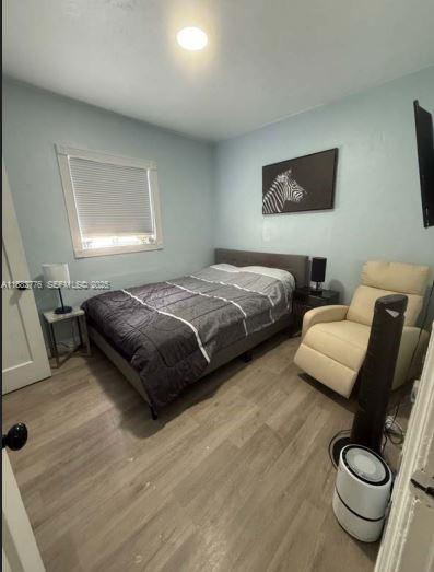 1336 Northwest 38th Street, Unit 1 Miami, FL 33142 - Photo 19 of 33 a bedroom with two beds and a couch