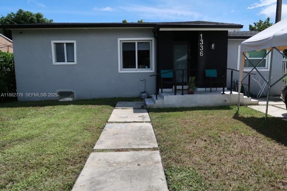 1336 Northwest 38th Street, Unit 1 Miami, FL 33142 - Photo 2 of 33 a front view of house with yard