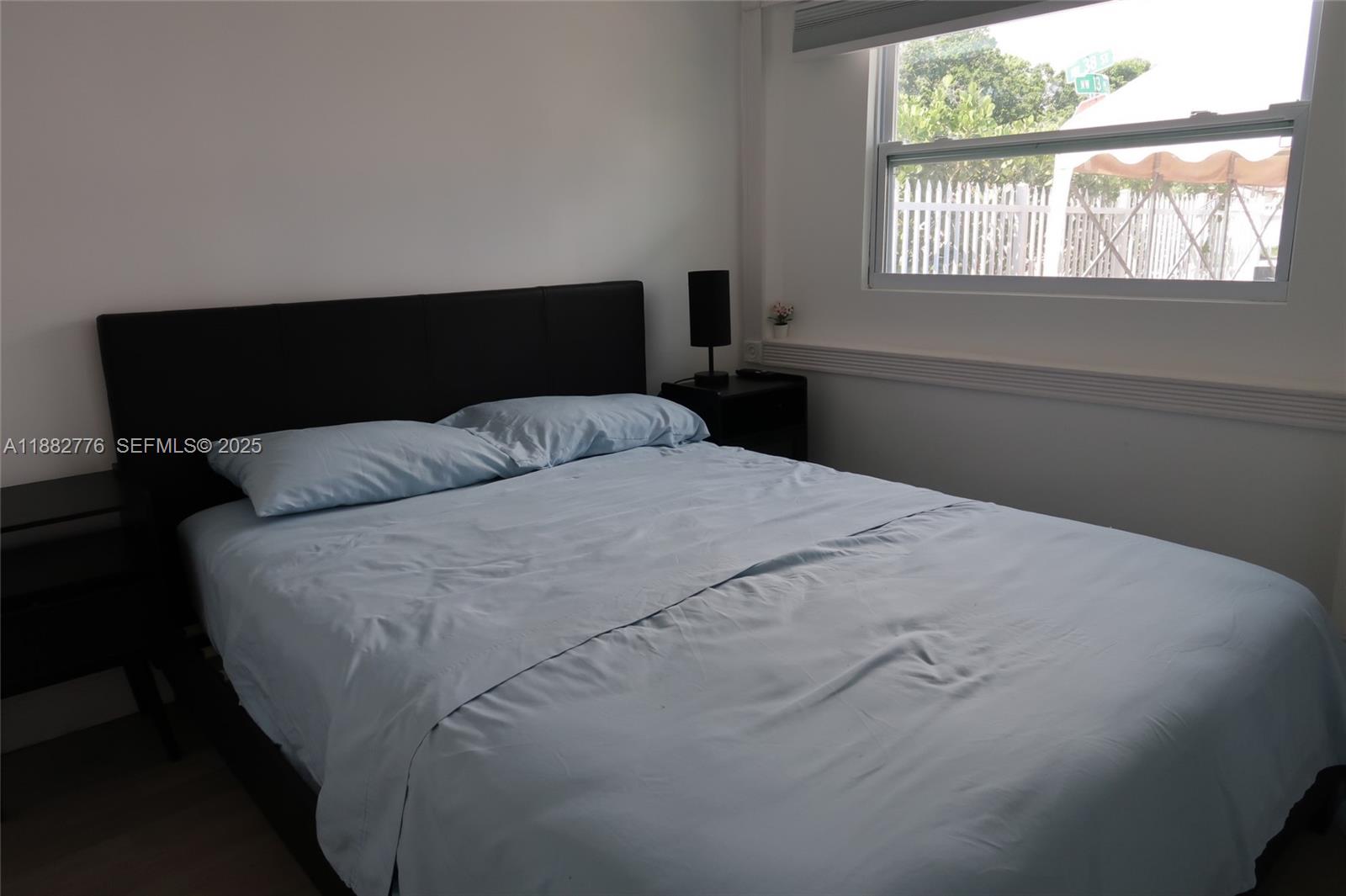 1336 Northwest 38th Street, Unit 1 Miami, FL 33142 - Photo 26 of 33 a bedroom with a bed and window
