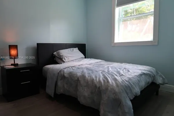 a bedroom with a bed and window