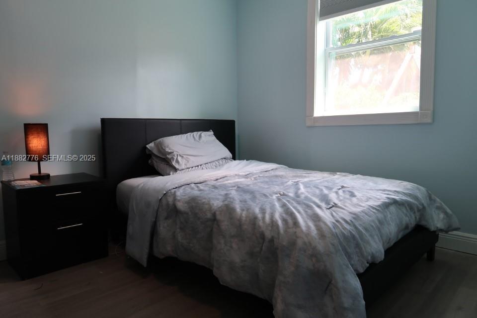 1336 Northwest 38th Street, Unit 1 Miami, FL 33142 - Photo 4 of 33 a bedroom with a bed and window