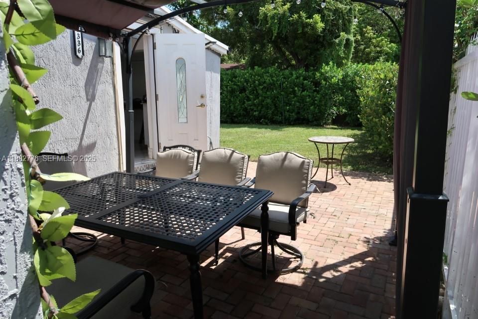 1336 Northwest 38th Street, Unit 1 Miami, FL 33142 - Photo 6 of 33 a view of balcony with a potted plant and outdoor seating