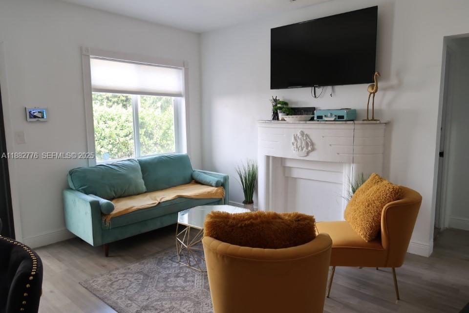 1336 Northwest 38th Street, Unit 1 Miami, FL 33142 - Photo 8 of 33 a living room with furniture and a flat screen tv