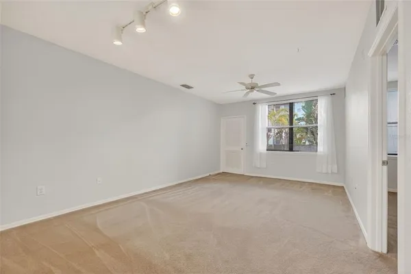 an empty room with windows and cabinet