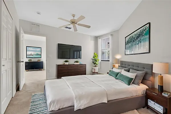 a bedroom with a bed and a flat screen tv