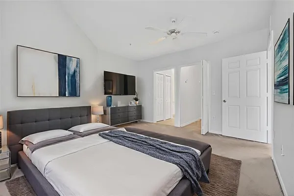a bedroom with a bed and a flat screen television