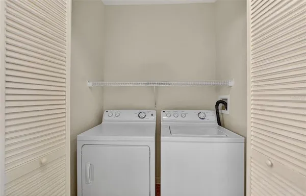 a view of a patio with a table and chairs under an umbrella