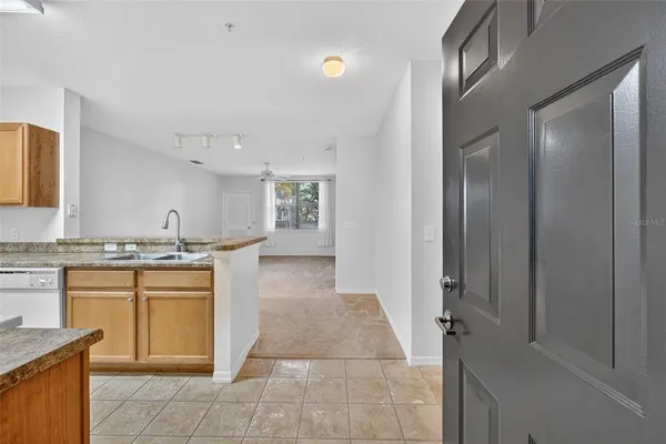 a kitchen with stainless steel appliances granite countertop a sink and a stove