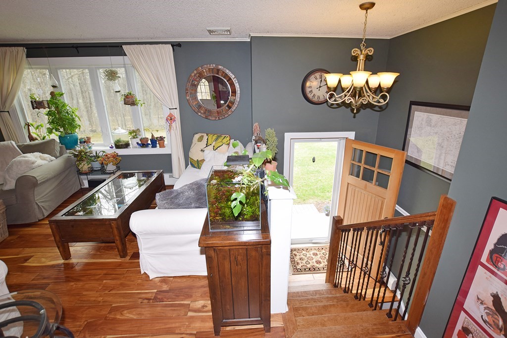 173 Hardwick Road Petersham, MA 01366 - Photo 16 of 37 a view of a dining room with furniture wooden floor and chandelier
