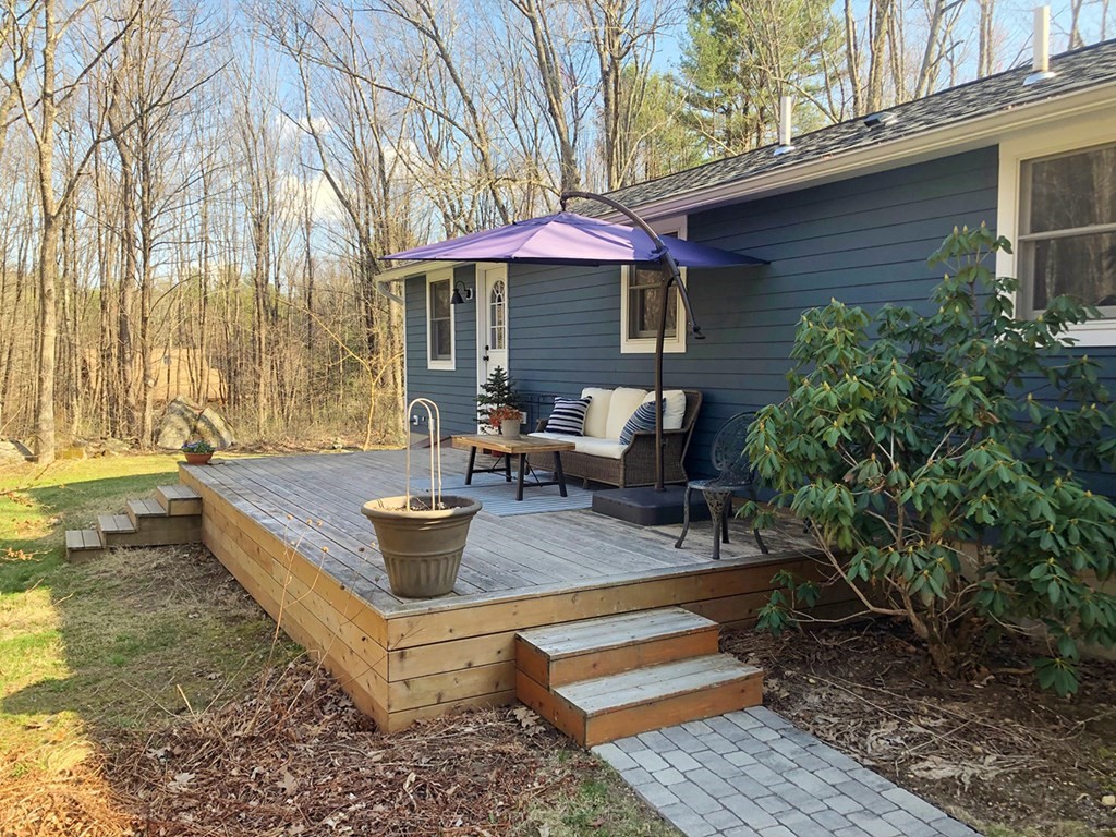 173 Hardwick Road Petersham, MA 01366 - Photo 26 of 37 a view of a house with backyard sitting area and tub