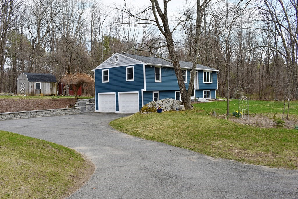 173 Hardwick Road Petersham, MA 01366 - Photo 3 of 37 a front view of a house with a yard and garage