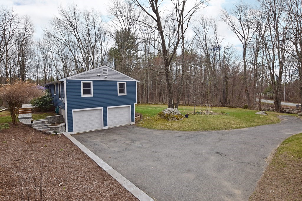 173 Hardwick Road Petersham, MA 01366 - Photo 31 of 37 a front view of a house with a yard and garage