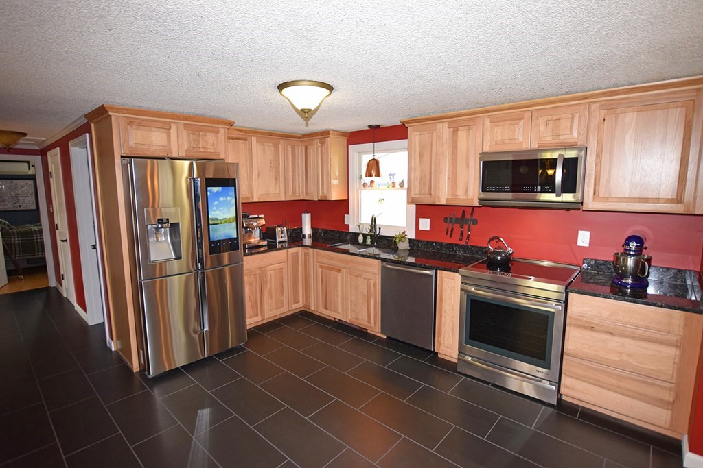 173 Hardwick Road Petersham, MA 01366 - Photo 4 of 37 a kitchen with stainless steel appliances granite countertop a stove a sink and a refrigerator
