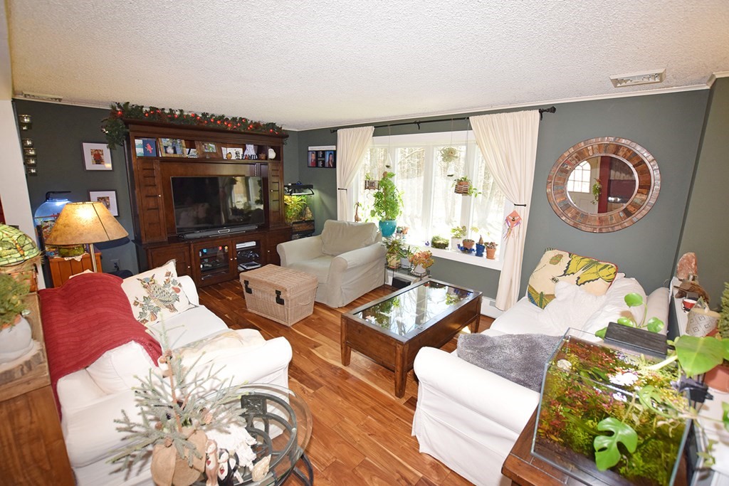 173 Hardwick Road Petersham, MA 01366 - Photo 8 of 37 a living room with furniture and a fireplace
