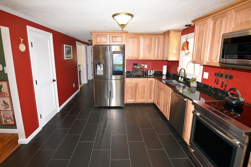 173 Hardwick Road Petersham, MA 01366 - Photo 9 of 37 a kitchen with stainless steel appliances a stove microwave and refrigerator