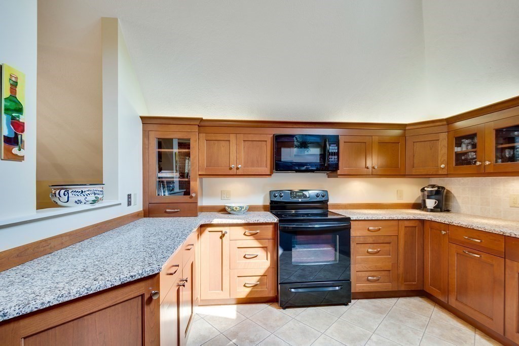 149 Andover Street, Unit 10 Andover, MA 01810 - Photo 13 of 30 a kitchen with stainless steel appliances granite countertop a stove and a sink