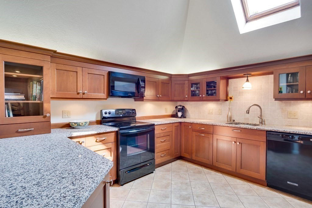 149 Andover Street, Unit 10 Andover, MA 01810 - Photo 14 of 30 a kitchen with stainless steel appliances granite countertop a sink stove and oven