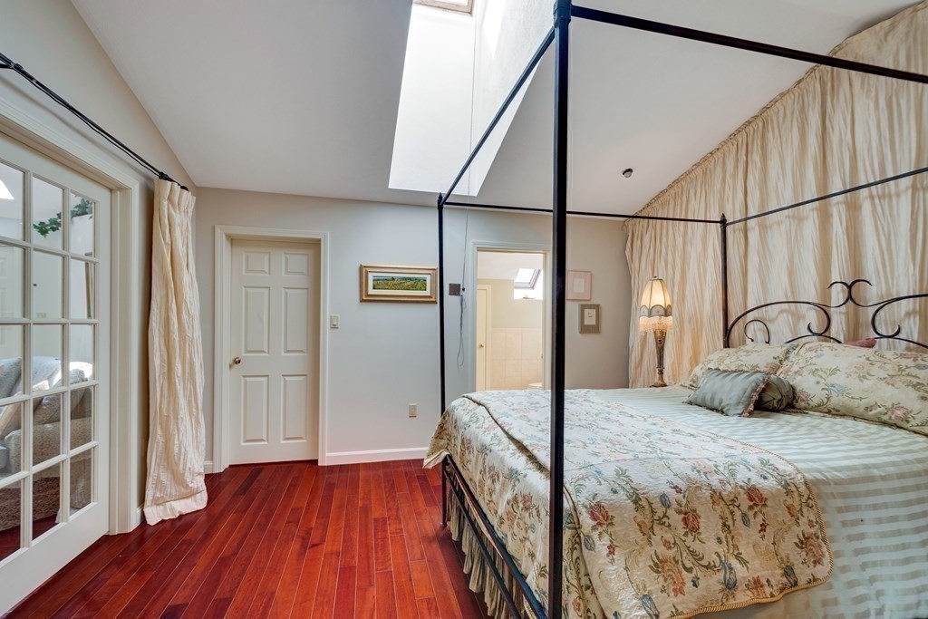 149 Andover Street, Unit 10 Andover, MA 01810 - Photo 18 of 30 a bedroom with a bed and a mirror