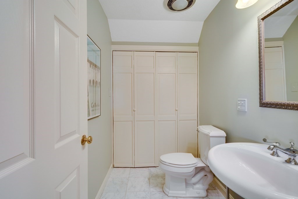 149 Andover Street, Unit 10 Andover, MA 01810 - Photo 27 of 30 a white toilet sitting next to a bathroom sink