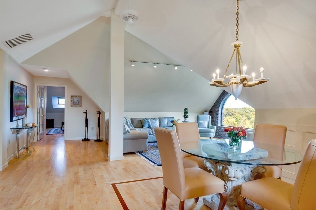 149 Andover Street, Unit 10 Andover, MA 01810 - Photo 10 of 30 a view of a dining room with furniture wooden floor and chandelier