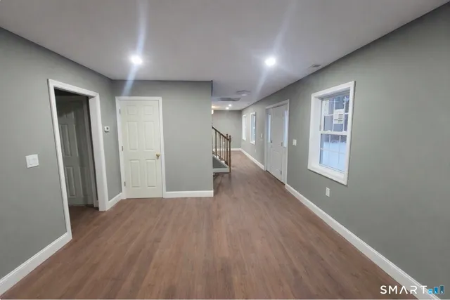 a view of a hallway with wooden floor