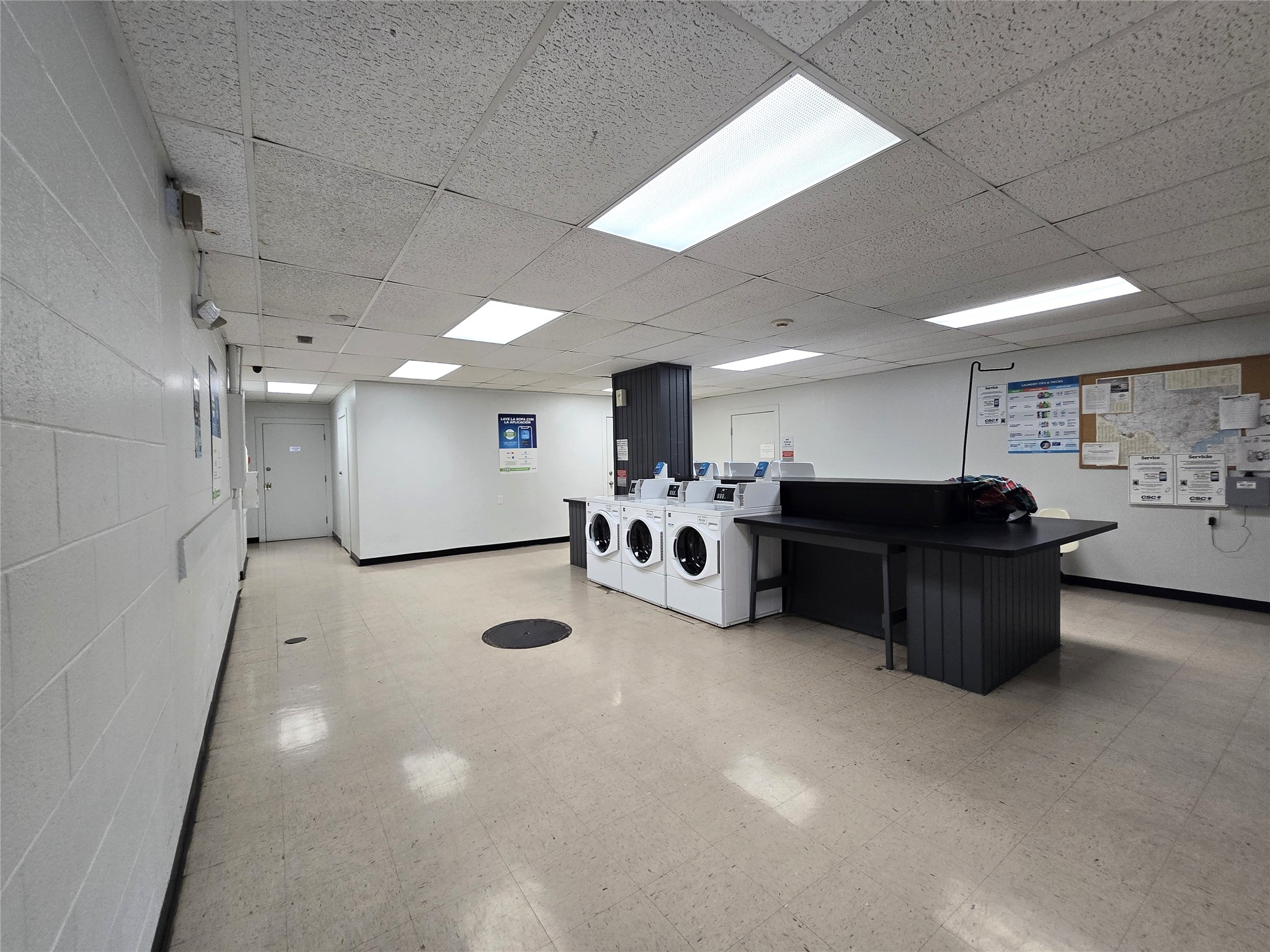 1800 Lavaca Street, Unit 107 Austin, TX 78701 - Photo 13 of 16 A spacious common laundry facility offers multiple machines and extensive counter space.