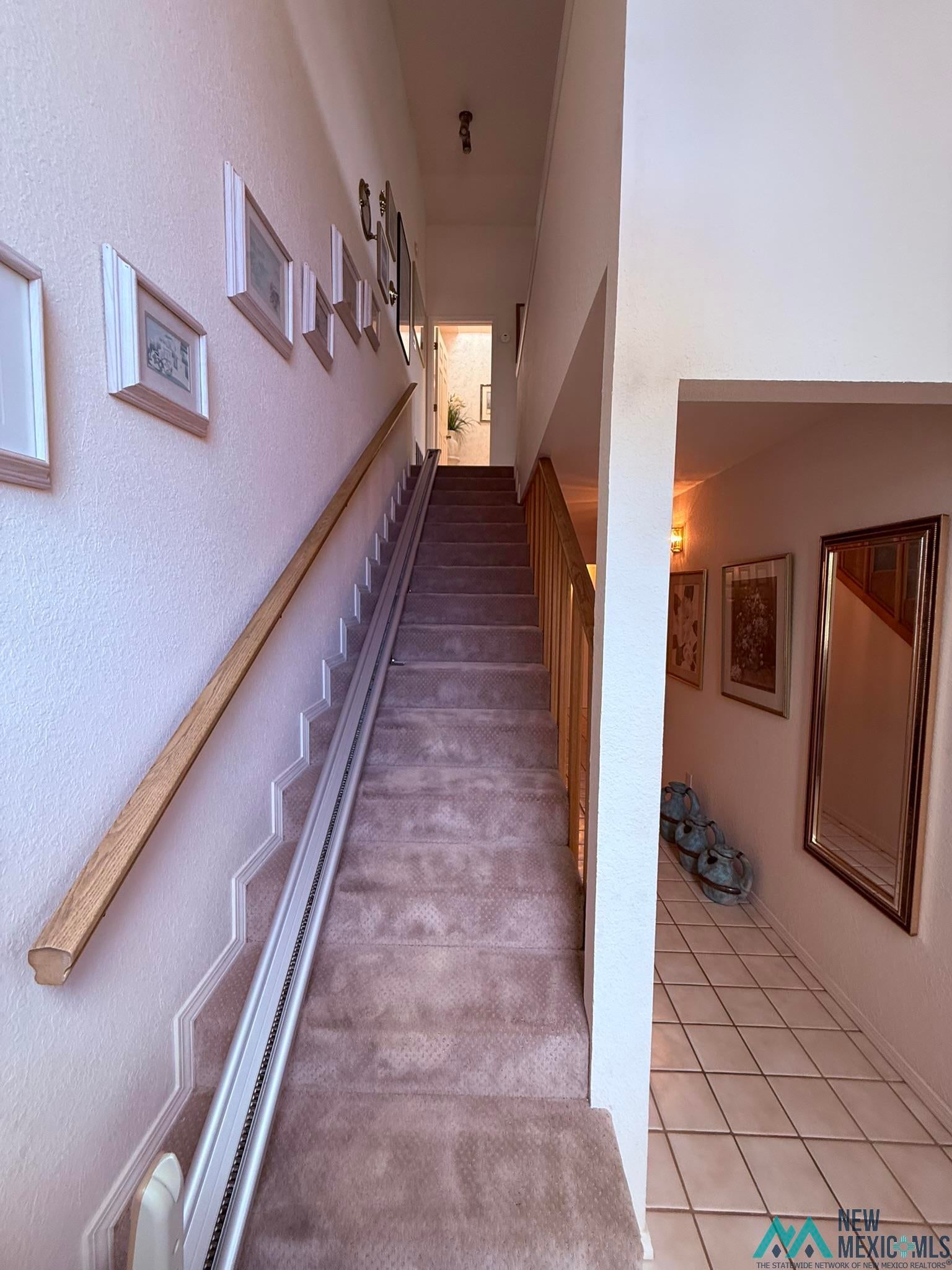 300 Rio Grande Circle Elephant Butte, NM 87935 - Photo 39 of 99 Carpeted staircase featuring a wooden handrail and a built-in stair lift system