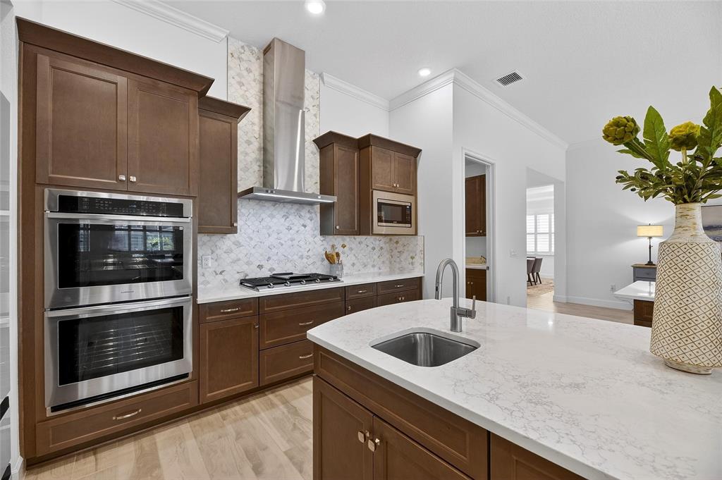 994 Signet Drive Apollo Beach, FL 33572 - Photo 26 of 98 a kitchen with stainless steel appliances granite countertop a sink stove and refrigerator
