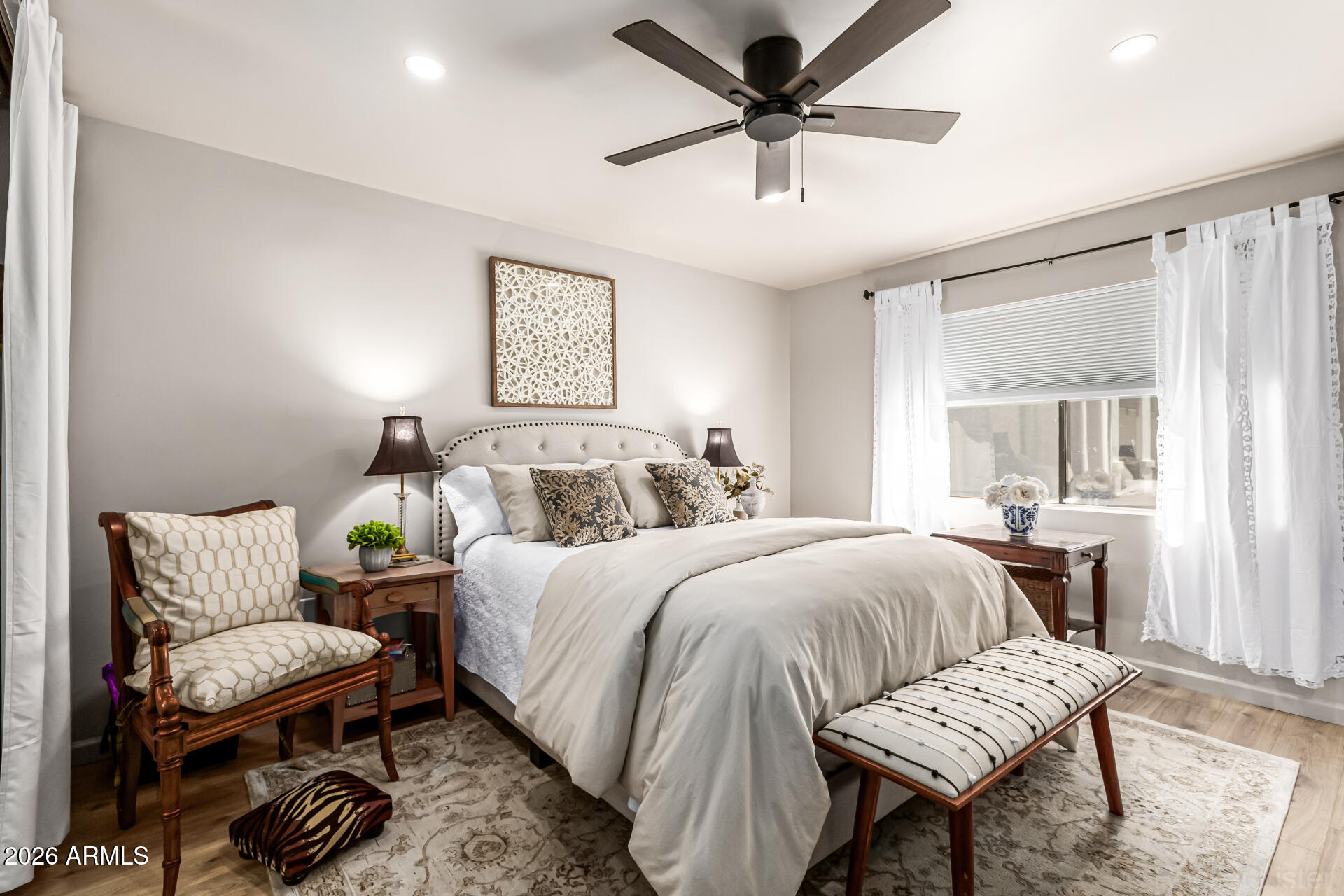 3033 East Devonshire Avenue, Unit 1032 Phoenix, AZ 85016 - Photo 12 of 23 a bedroom with a bed and a chandelier