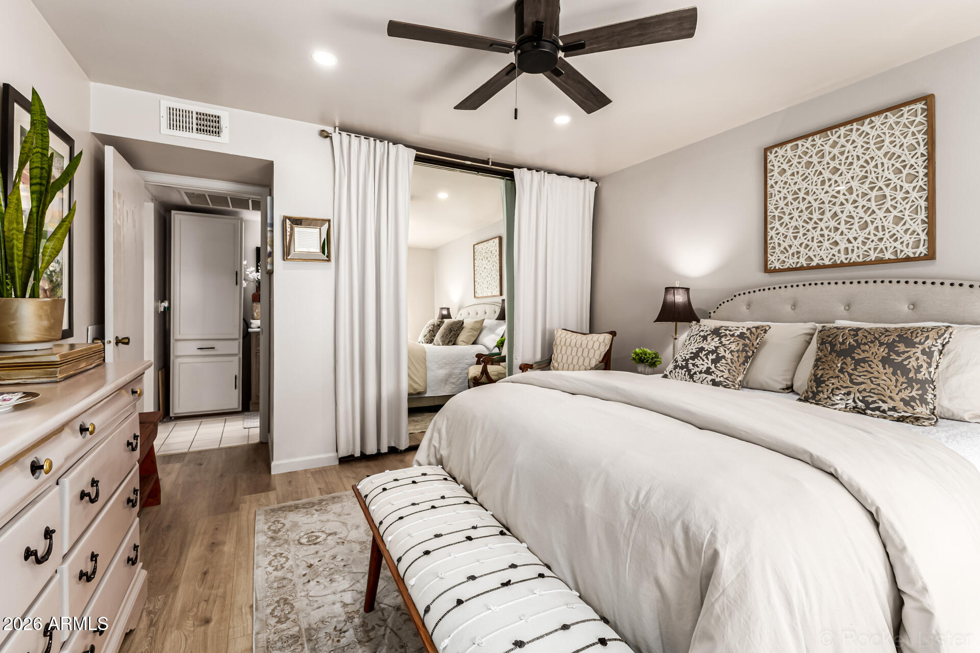 3033 East Devonshire Avenue, Unit 1032 Phoenix, AZ 85016 - Photo 13 of 23 a bedroom with a large bed and a flat tv screen