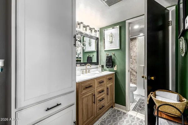 a bathroom with a double vanity sink and a mirror