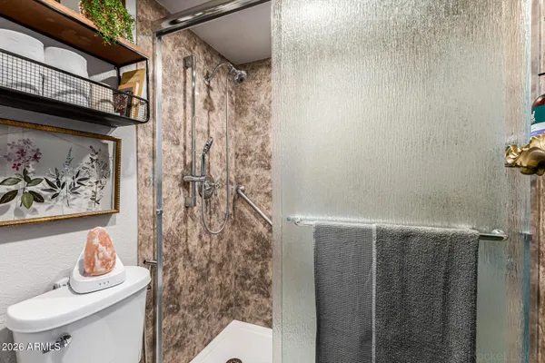 a bathroom with a toilet and shower curtain