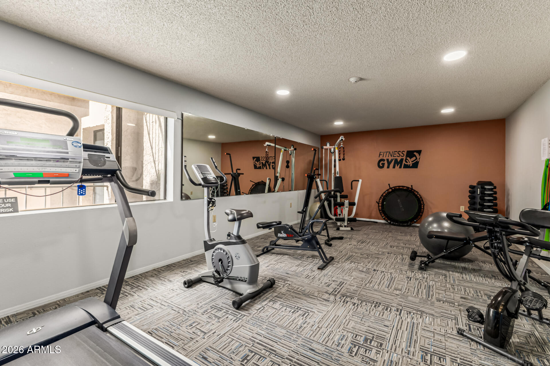 3033 East Devonshire Avenue, Unit 1032 Phoenix, AZ 85016 - Photo 19 of 23 a view of a room with gym equipment