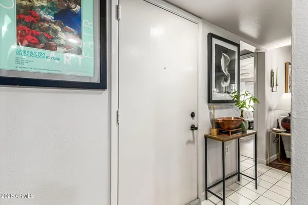 a view of a hallway with wooden floor and a bookshelf