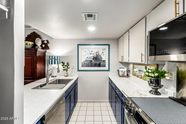 a kitchen with a sink stove and cabinets