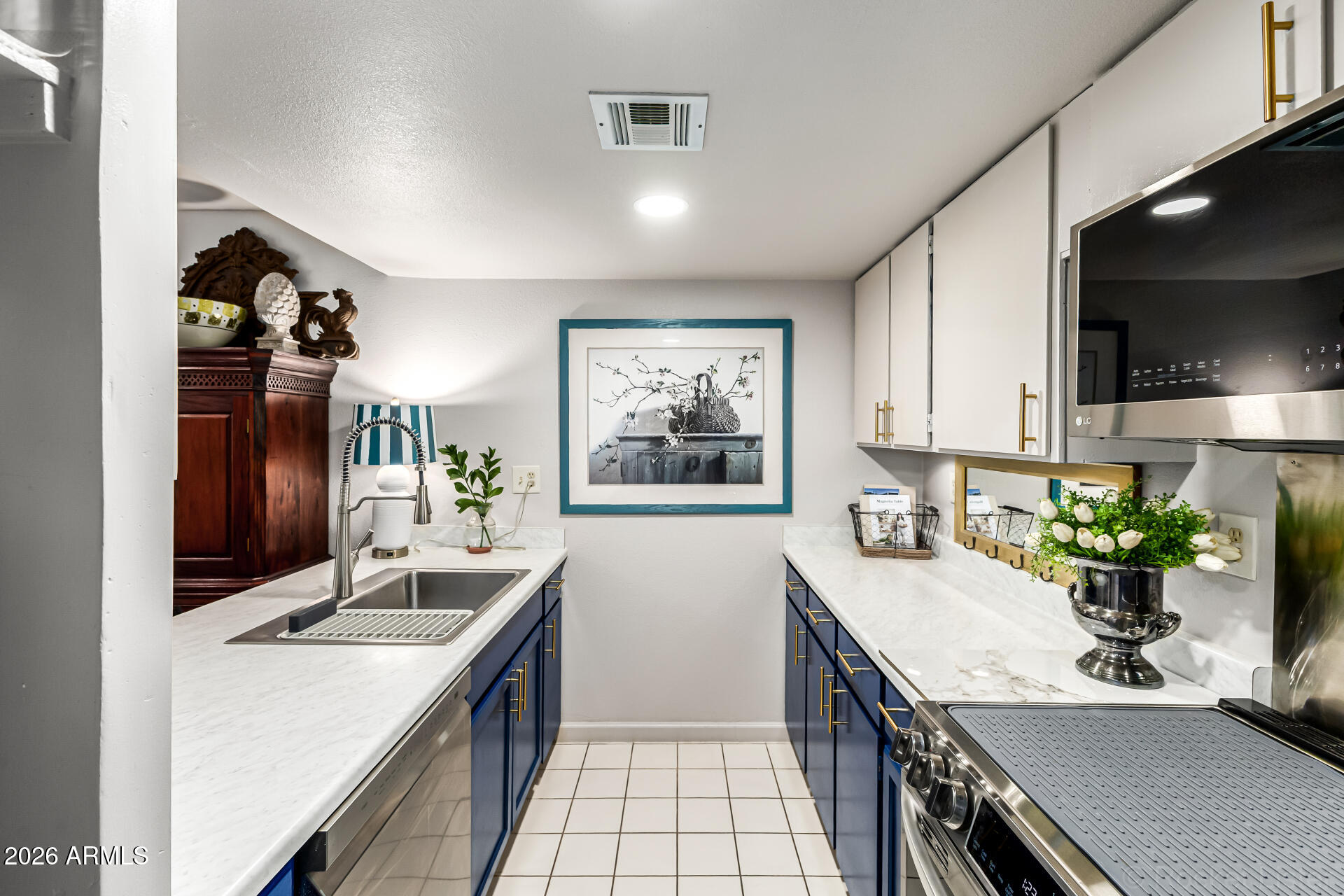 3033 East Devonshire Avenue, Unit 1032 Phoenix, AZ 85016 - Photo 9 of 23 a kitchen with a sink stove and cabinets