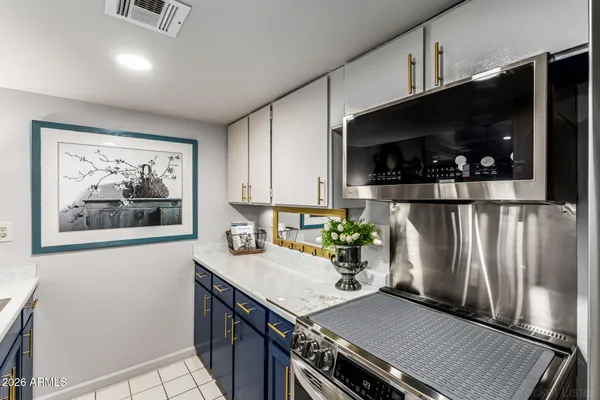 a kitchen with stainless steel appliances a stove refrigerator and microwave