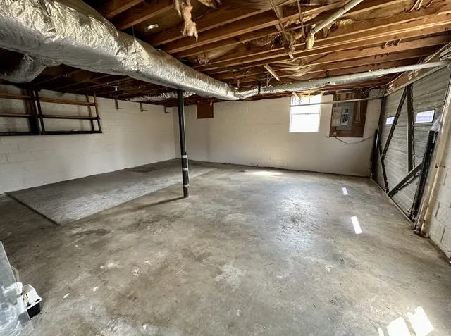 a view of empty room with wooden ceiling