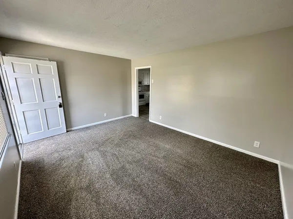 a view of an empty room and a window