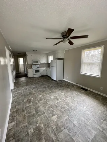 a view of a livingroom with furniture and windows