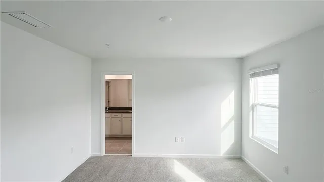an empty room with windows and closet