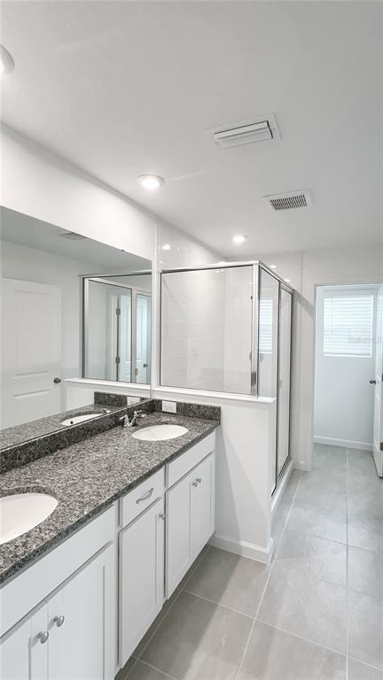 4268 Sadler Road Apopka, FL 32712 - Photo 18 of 28 a bathroom with a granite countertop sink and mirror