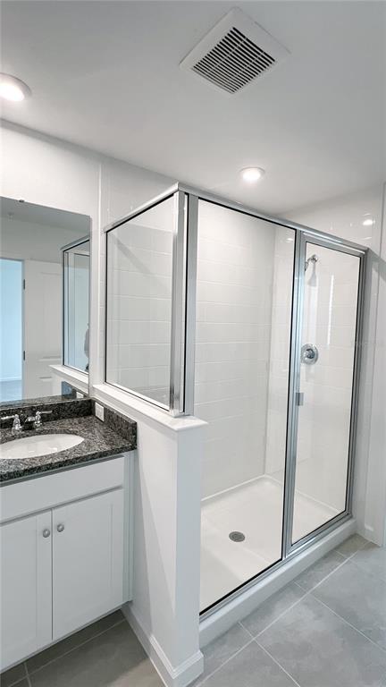 4268 Sadler Road Apopka, FL 32712 - Photo 19 of 28 a bathroom with a granite countertop sink mirror and shower