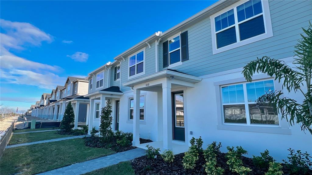 4268 Sadler Road Apopka, FL 32712 - Photo 2 of 28 a front view of a house with garden