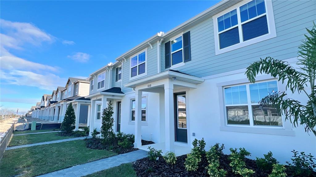 4268 Sadler Road Apopka, FL 32712 - Photo 3 of 28 a front view of a house with garden